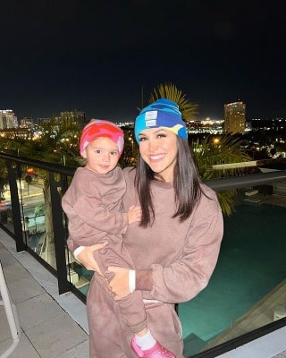 Kat wearing chocolate color set trousers. 